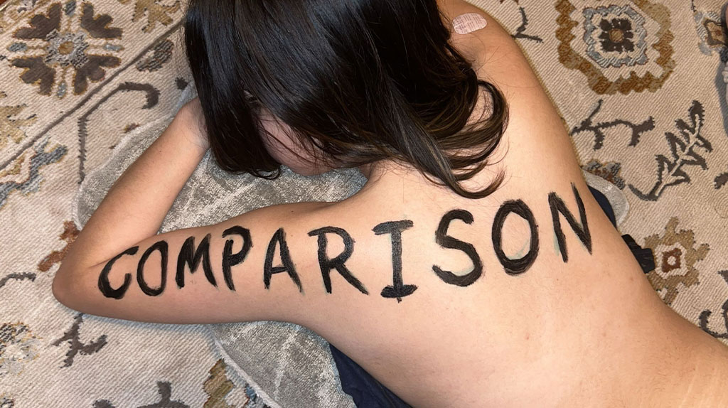 the word comparison is pained on my back and arm