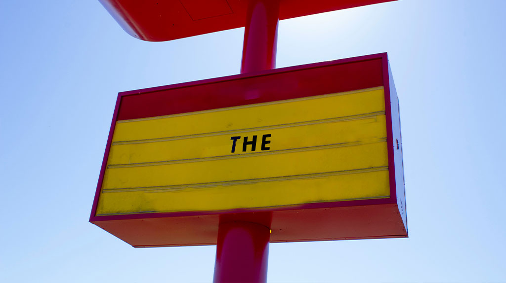 the word the photoshopped in a billboard of a fast food place.